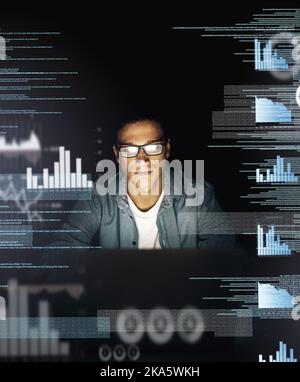 Im all about cracking codes. a young computer programmer looking through data in the dark. Stock Photo