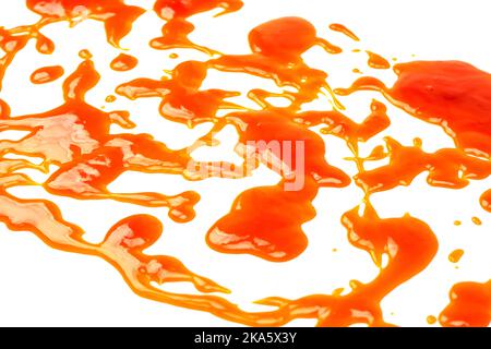 Orange sauce splashes isolated on white a background. Top view. Stock Photo