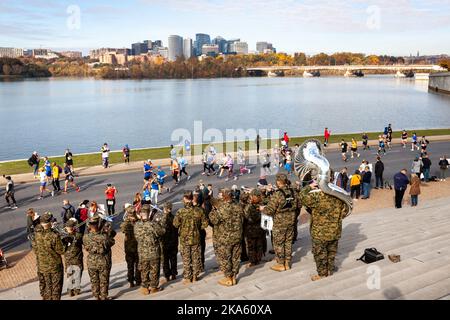 Washington, United States. 30th Oct, 2022. A Marine band plays for runners on the Watergate Steps during the 2022 Marine Corps Marathon. The annual event draws tens of thousands of runners, and people from all 50 US states and 48 countries participated in this year's race. (Photo by Allison Bailey/SOPA Images/Sipa USA) Credit: Sipa USA/Alamy Live News Stock Photo