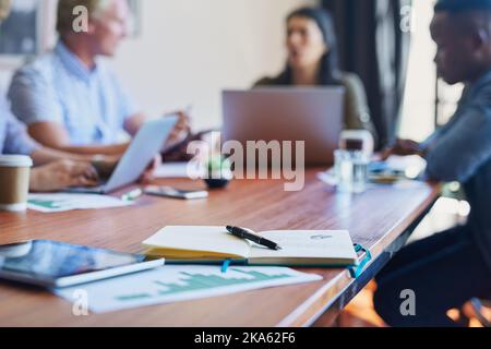 Where the creative talent comes to meet. an open notebook on the table in a meeting room. Stock Photo