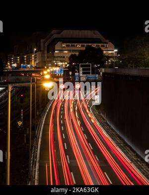 Berlin, Germany. 31st Oct, 2022. Vehicles can only be seen as streaks of light in the long exposure on the A100 city highway. The ICC (International Concress Center), which has been closed for years, can be seen in the background. Credit: Paul Zinken/dpa/Alamy Live News Stock Photo