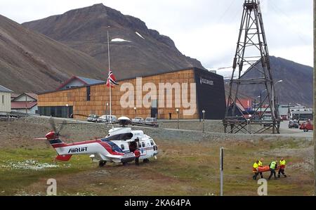 Polar bear attacked British tourists, one killed. Four people from a British tourist group were transported by helicopter to Longyearbyen hospital with injuries after being attacked by a Polar Bear at the Von Post glacier on Friday morning. Photo shows one of the injured brought out from the helicopter after their arrival in Longyearbyen. Stock Photo