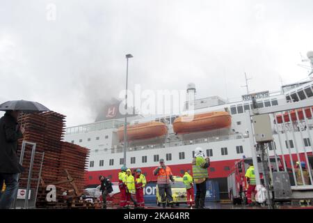 Fire and rescue teams tackle the fire aboard the cruise ship MS Nordlys, shown at the dock in Alesund, Norway. Stock Photo