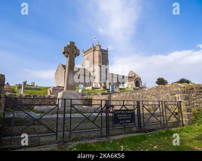 The war memorial and Old Church of St Nicholas at Uphill, Weston-super-Mare, North Somerset, England. Stock Photo