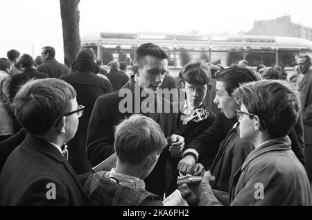 Edinburgh, Scotland - January 1965.Roald 'Kniksen' Jensen has become a professional footballer in Scotland with Heart of Midlothian.  Here he writes autographs for some young boys. Photo: Sverre A. Boerretzen / Aktuell / NTB Scanpix  Stock Photo