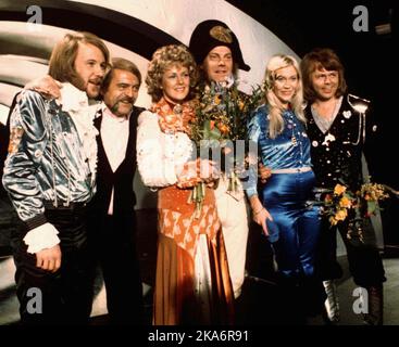 FILE - In this April 6, 1974 file photo, members of Swedish group ABBA and close associates celebrate the victory of their song 'Waterloo' in the Eurovision Song Contest in Brighton, England. The four members of ABBA, Benny Andersson, left, Annifrid Lyngstad, third left, Agnetha Faltskog, second right, and Bjorn Ulvaeus, right, , second right, were the most successful winners of the Eurovision Song Contest, enjoying unprecedented success after their victory. The final of this year's competition takes place on Saturday, May 14 in the Swedish capital Stockholm. (AP Photo/File) Stock Photo