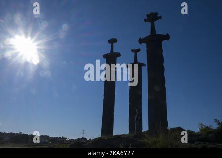 Stavanger, Norway 20170704. Fritz Roed's monument to the battle of Hafrsfjord, Sverd i fjell (Swords in Rock) . The three bronze swords stand 10 metres (33 ft) tall and are planted into the rock of a small hill next to the fjord. They commemorate the historic Battle of Hafrsfjord which by tradition took place there in the year 872. Photo: Vidar Ruud / NTB scanpix Stock Photo