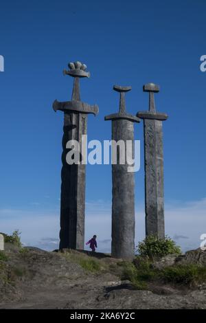 Stavanger, Norway 20170704. Fritz Roed's monument to the battle of Hafrsfjord, Sverd i fjell (Swords in Rock) . The three bronze swords stand 10 metres (33 ft) tall and are planted into the rock of a small hill next to the fjord. They commemorate the historic Battle of Hafrsfjord which by tradition took place there in the year 872. Photo: Vidar Ruud / NTB scanpix Stock Photo