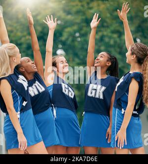 Netball, sports and motivation with a woman team in celebration after victory in a competitive game on a court. Fitness, collaboration and training Stock Photo