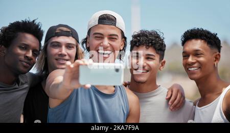 Team, phone and friends with smile for selfie in fun sport, exercise or training together in the outdoors. Group portrait of athletic men smiling for Stock Photo