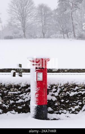 UK red post box covered in snow - Scotland, UK Stock Photo