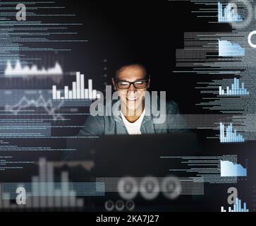 Cracking codes is his speciality. a young computer programmer looking through data in the dark. Stock Photo
