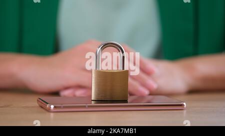 Closed metal lock on modern smartphone, mobile phone security Stock Photo