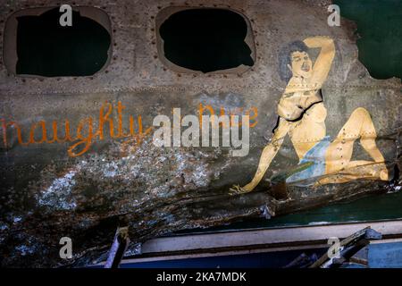 Panel from wreckage of B17 bomber displaying nose art Naughty but Nice with painted lady.  Kokopo War Museum, Kokopo Papua New Guinea Stock Photo