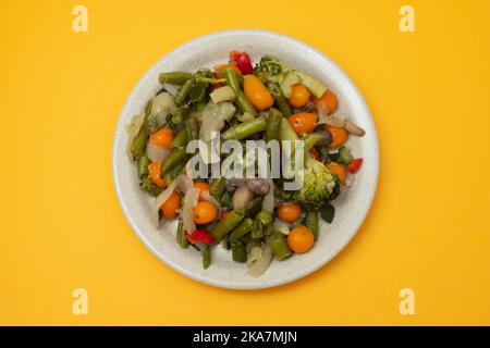 Mixed boiled vegetables on light brown dish Stock Photo
