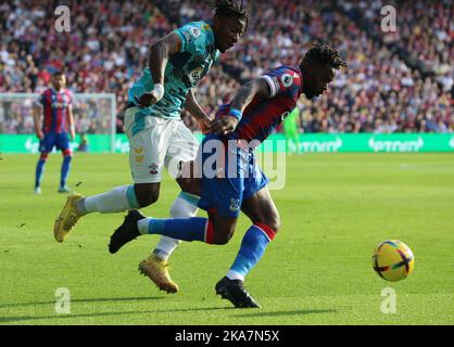 London ENGLAND - October 29: Crystal Palace's Jeffrey Schlupp holds of Southampton's Mohammed Salisu during English Premier League soccer match betwee Stock Photo