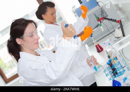 female lboratory technicians using pipettes in the laboratory Stock Photo