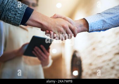 Its a done deal. Closeup shot of unrecognizable businesspeople shaking hands in an office. Stock Photo