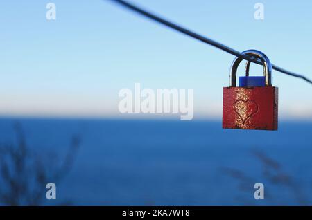 Love lock hanging on a bridge in Slovenia. Adriatic sea. Valentine's Day background. sign of love and loyalty for a wedding. Stock Photo