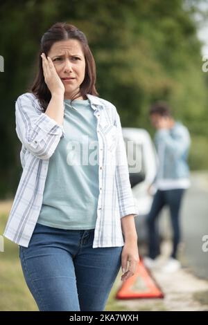 couple after a car breakdown on the road Stock Photo