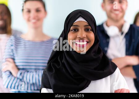 Diverse teenagers using mobile devices while posing for a studio photo in front of a colorful background Stock Photo