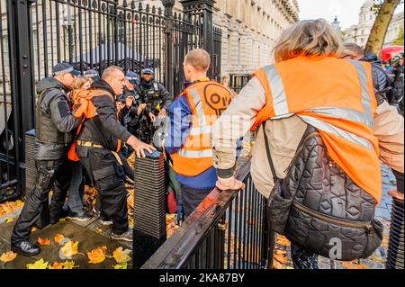 London, UK. 1st Nov, 2022. Just stop oil continue their daily protest in Westminster with the aim of getting the Government to stop all new oil fields. They briefly attempt to climb the Downing street gate and then attempt to block Whitehall traffic for a short period. Credit: Guy Bell/Alamy Live News Stock Photo