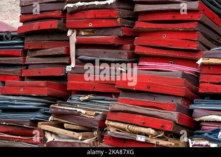 Bunch of old broken chair seats on backyard of theatre. Stock Photo