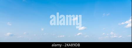 Blue panoramic sky background with small white clouds Stock Photo