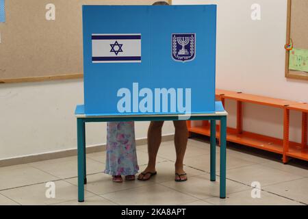 Tel Aviv, Israel. 01st Nov, 2022. An Israeli voter casts a ballot during Israel's fifth election in less than four years at a polling station in Israel's coastal city of Tel Aviv on Tuesday, November 1, 2022. Lapid urged the electorate to cast their ballot after voting in an election that might see veteran leader Benjamin Netanyahu making a comeback alongside far-right allies. Pool Photo by Jack Guez/UPI Credit: UPI/Alamy Live News Stock Photo