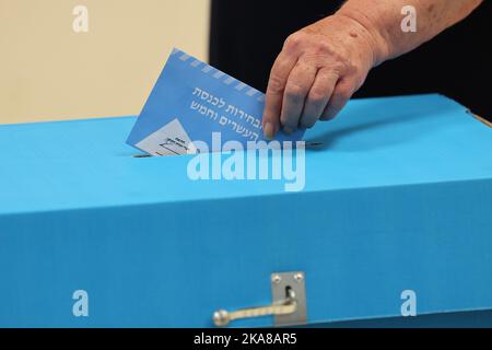 Tel Aviv, Israel. 01st Nov, 2022. An Israeli voter casts a ballot during Israel's fifth election in less than four years at a polling station in Israel's coastal city of Tel Aviv on Tuesday, November 1, 2022. Lapid urged the electorate to cast their ballot after voting in an election that might see veteran leader Benjamin Netanyahu making a comeback alongside far-right allies. Pool Photo by Jack Guez/UPI Credit: UPI/Alamy Live News Stock Photo