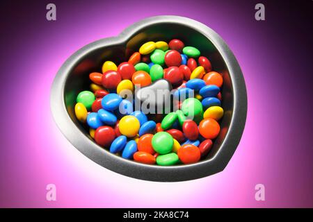 Chocolate Lollies in Heart-shaped Cake Mould Stock Photo