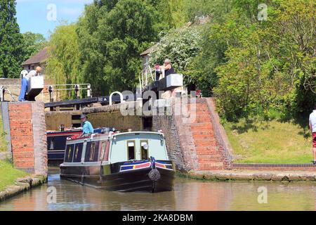 Lock gates at stoke Bruerne canal in n Northamptonshire, United Kingdom. Barges coming through locks. Very popular for sight seers and barges. Stock Photo