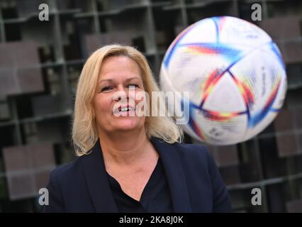 Doha, Qatar. 01st Nov, 2022. Nancy Faeser (SPD), Federal Minister of the Interior and Home Affairs, catches a World Cup soccer ball. Faeser has traveled to the host country Qatar in her capacity as sports minister in the run-up to the World Cup. The trip will focus on the human rights issues being discussed around the tournament. Credit: Britta Pedersen/dpa/Alamy Live News Stock Photo