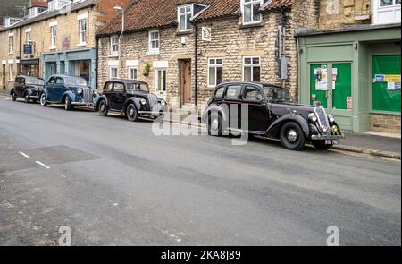 Old cars parked opposite Pickering station during the North Yorkshire Moor's railway's war weekend. Stock Photo