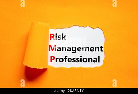 RMP risk management professional symbol. Concept words RMP risk management professional on white paper on a orange background. Business RMP risk manag Stock Photo