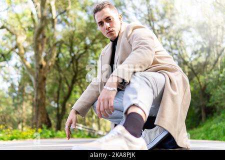Young hispanic arab man posing in the road looking at camera, copy space Stock Photo