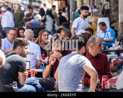 Picture of terraces of kebab, fast foods and cafes in the streets of Istanbul, turkey, full of men drinking and eating. Stock Photo