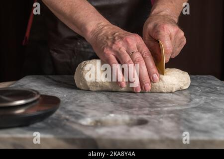 Man preparing pizza, dough on marble table. Stock Photo