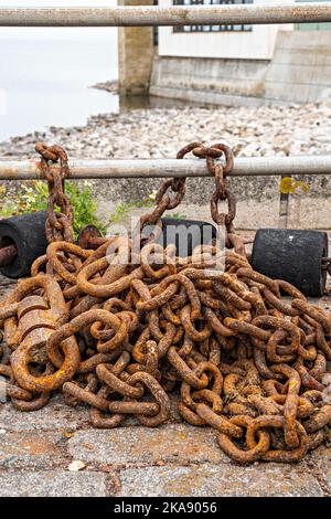 Rusty chains on quayside Stock Photo