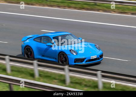 2022 Blue PORSCHE 911 CARRERA GTS coupe 3.0-litre bi-turbo flat-six , travelling on the M6 Motorway UK Stock Photo