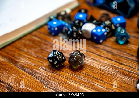 Multiple gaming dice on wooden table used for role playing adventures.  Stock Photo