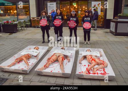 London, UK. 01st Nov, 2022. PETA (People for the Ethical Treatment of Animals) activists seen packaged as “Free-range human meat” during a protest outside Whole Foods store next to Piccadilly Circus on World Vegan Day to highlight the fact that 'humane' labels on meat are meaningless, to remind people of the horrors of the meat industry, and to promote veganism. Credit: SOPA Images Limited/Alamy Live News