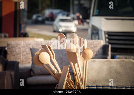 Picture of various kitchen utensils on display , with a focus on a wooden spoon. Stock Photo
