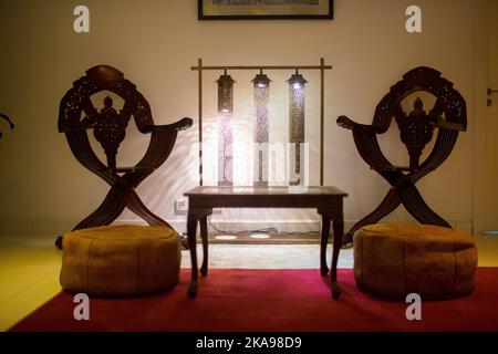 Wooden table with two wooden armchairs next to it in a hotel Stock Photo