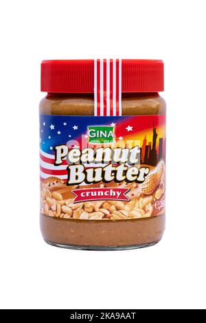 Peanut butter crunchy with roasted peanut pieces from a company Gina. The closed jar with logo isolated on a white background. Illustrative editorial Stock Photo