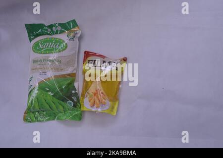 Packaged rice and cooking oil on a white background Stock Photo