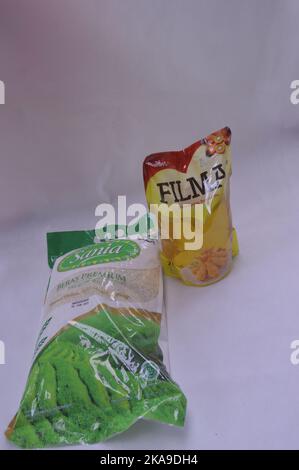 Packaged rice and cooking oil on a white background Stock Photo