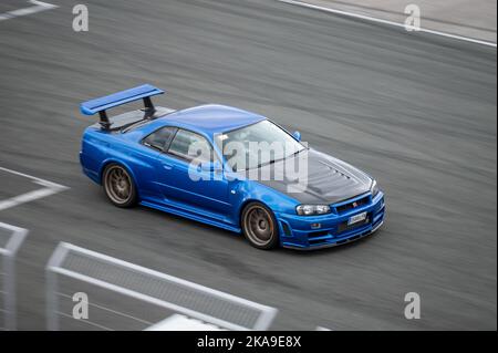Blue Nissan Skyline GTR R34 parked after the rain showing its tuning ...