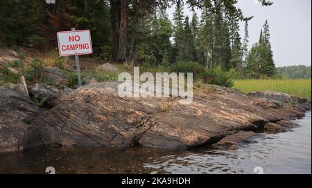 A no camping sign on the shore of Caddy Lake, Manitoba, Whiteshell Provincial Park Stock Photo