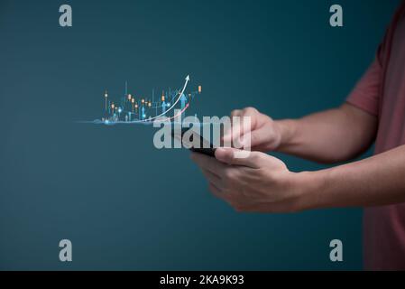 Hand of Businessman or trader planning strategy showing a growing virtual hologram stock of stock market to show business growth on smartphone, invest Stock Photo